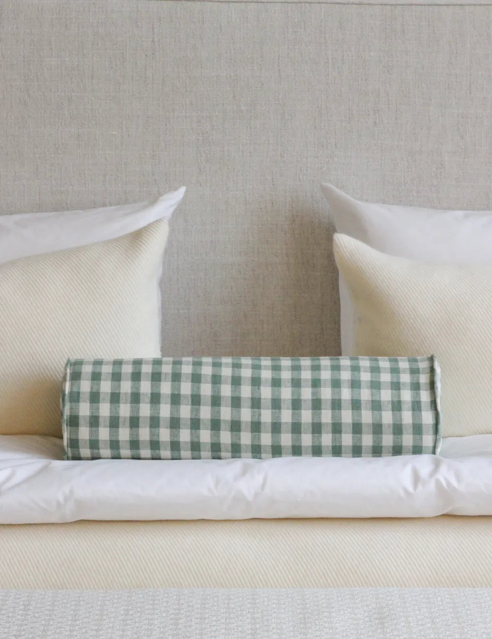 Bolster cushion in Minack Check Leaf by (Colefax and Fowler)